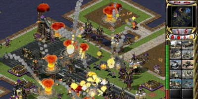 A neatly laid-out base is lit up by many explosions