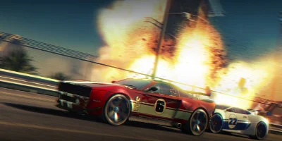 A red muscle car, racing a white super-car, as they speed past a large explosion