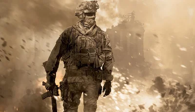 An armed soldier, walking casually through a warzone