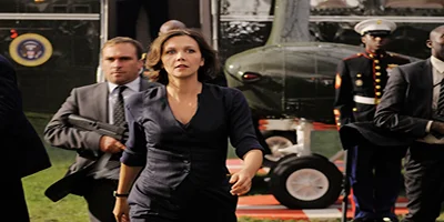 Maggie Gyllenhaal walking off a plane